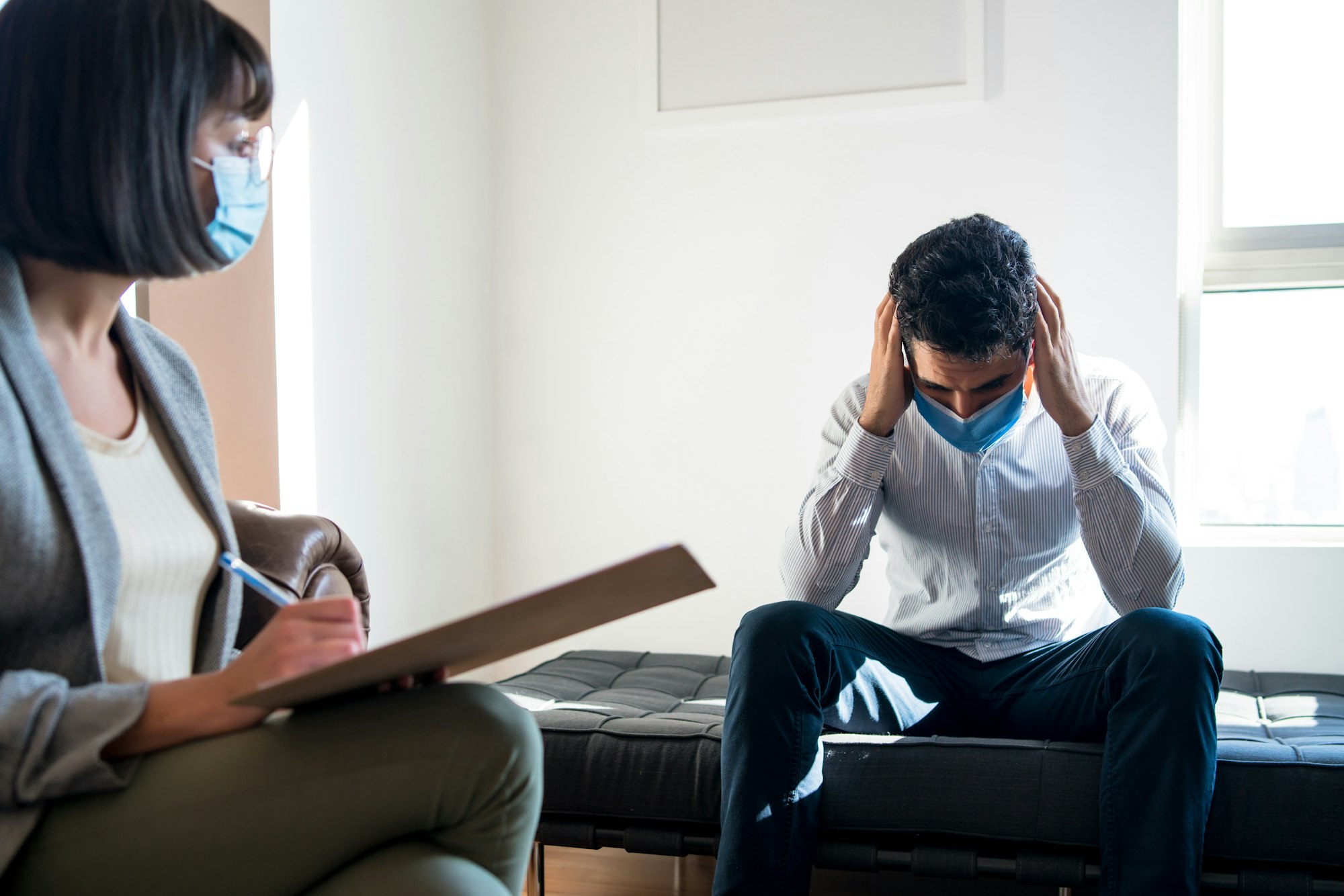 Psychologist talking with patient on therapy session.